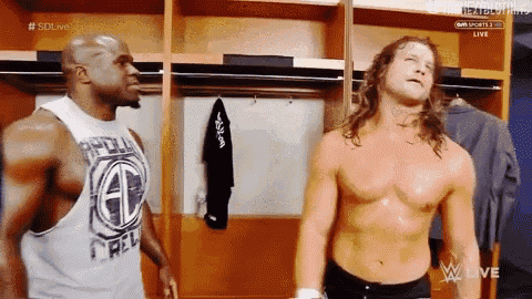 two wrestlers are standing in a locker room and one of them has a shirt that says gd