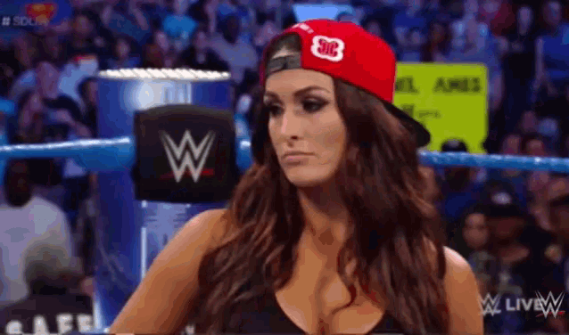 a woman in a wrestling ring wearing a red hat with the letter s on it
