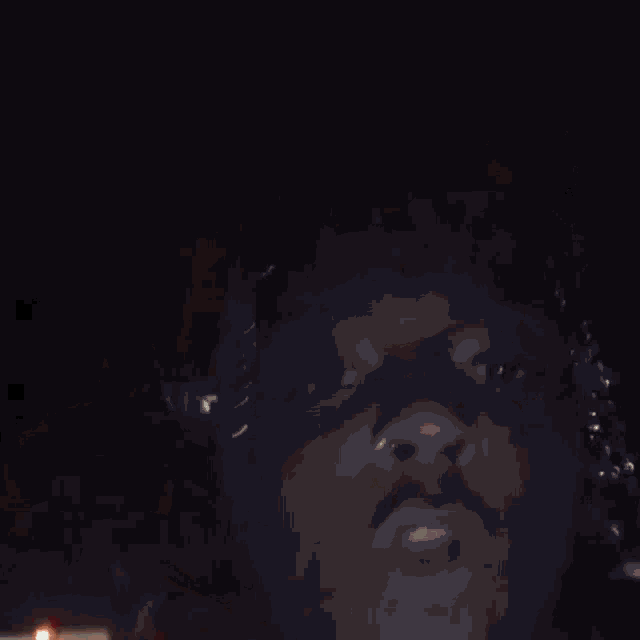 a blurred image of a person 's face with a light coming out of it
