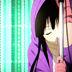 a woman in a purple hoodie is holding a pole