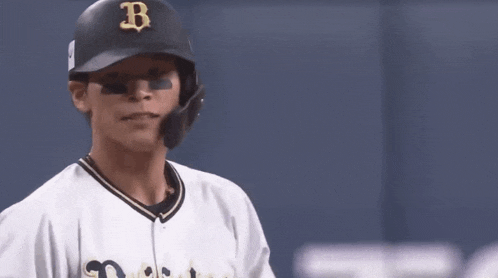 a baseball player with a sticker on his helmet that says left u