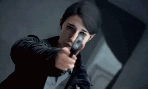 a woman in a black jacket is pointing a gun