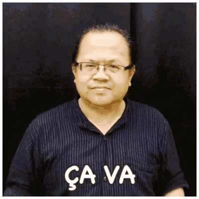 a man wearing glasses and a shirt that says cava on it