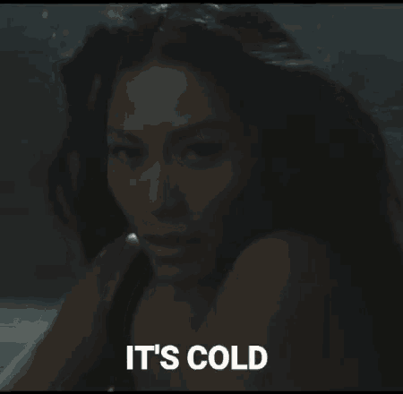 a woman is swimming in a bathtub with the words `` it 's cold '' written on the bottom .