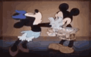 mickey mouse and minnie mouse are standing next to each other in a cartoon scene .