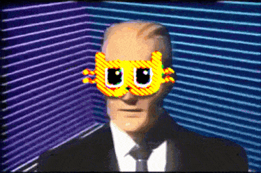 a man in a suit and tie is wearing a mask with a cat on it