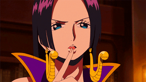 a woman in a purple and gold outfit has her finger on her lips
