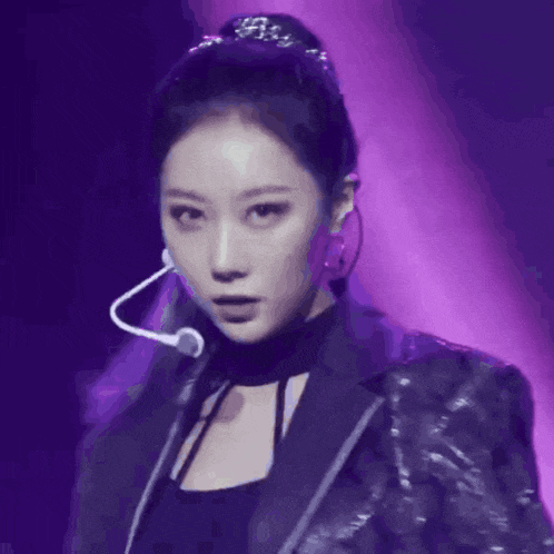 a close up of a woman with a microphone on her neck