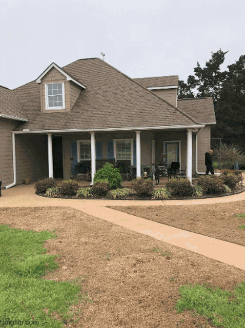 a large house with a porch and a walkway