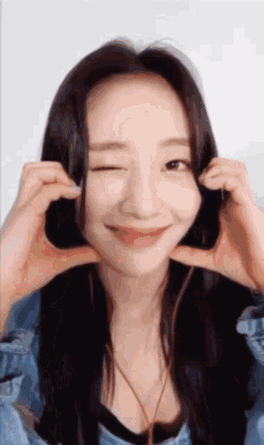 a woman is making a funny face with her hands