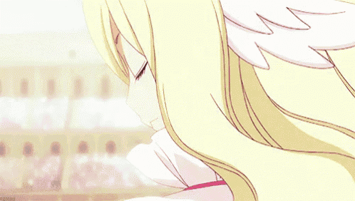 a close up of a blonde anime girl with wings on her ears and a star in her eyes .