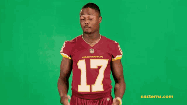 a man wearing a washington redskins jersey with the number 17