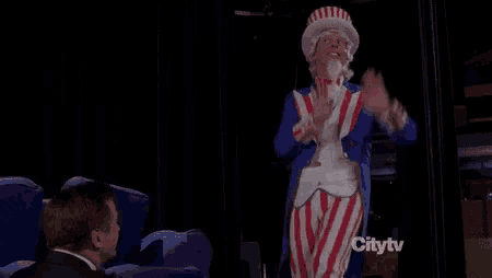 a man in a suit is standing in front of a man dressed as uncle sam