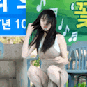 a woman in a dress is kneeling down in front of a sign that says 10