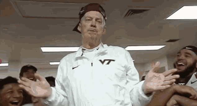 a man wearing a white jacket with vt on it