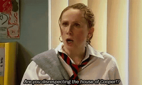 a woman wearing a tie and a white shirt is talking to another woman .