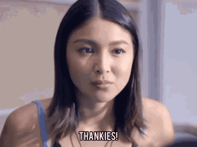 a woman in a bra is giving a thank you speech .