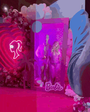 a man and woman are sitting inside of a barbie box