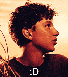a close up of a young man 's face with the letters d on the bottom