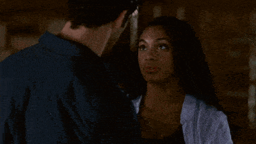 a man and a woman are looking into each others eyes