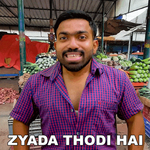 a man in a plaid shirt is smiling with the words zyada thodi hai below him
