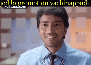 a man in a blue shirt and tie is smiling while wearing a lanyard with the word promotion on it .