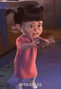 a little girl from monsters inc is standing in a room with her eyes closed .