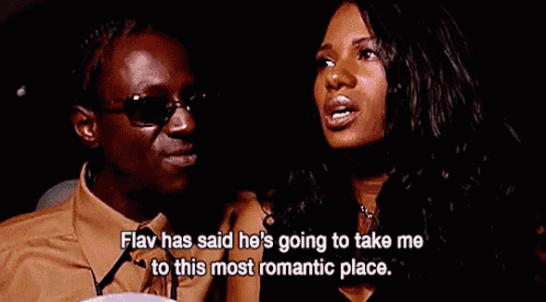 a man and a woman are sitting next to each other and the man is saying that he is going to take me to this most romantic place