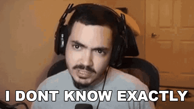 a man wearing headphones is sitting in a chair and making a funny face .