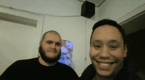 two men are posing for a picture and one of them has a beard