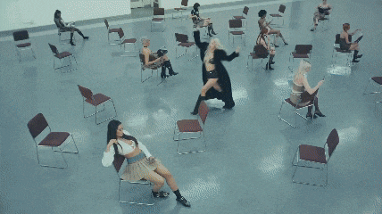 a group of young women are dancing in a mirrored room .