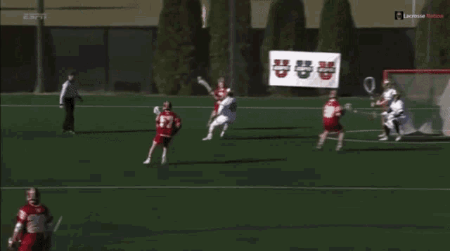 a lacrosse game is being played in front of an espn sign