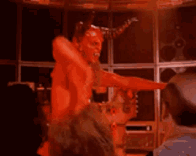 a devil with horns is pointing at a person