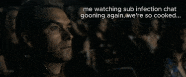 a man is watching a movie with a caption that says me watching sub infection chat going again we 're so cooked ...