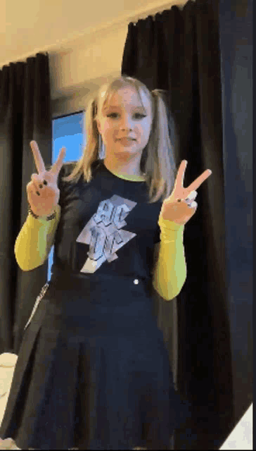 a girl wearing a black shirt that says ac on it