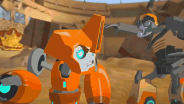 a couple of orange robots are standing next to each other in a desert .