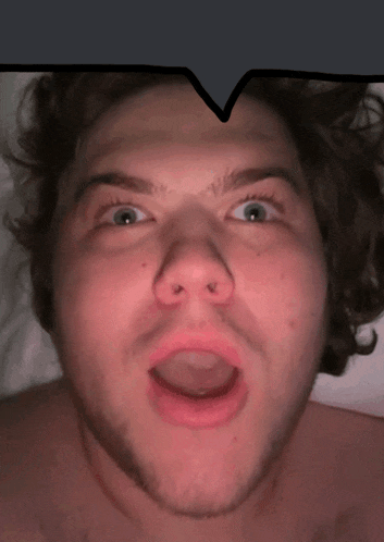 a close up of a man with his mouth open