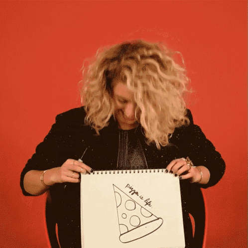 a woman is holding a drawing of a slice of pizza and the words pizza is life