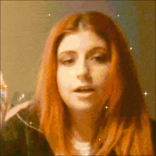 a pixelated image of a woman with red hair looking at the camera