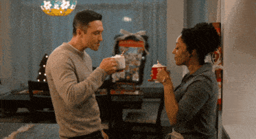 a man and a woman are drinking hot chocolate