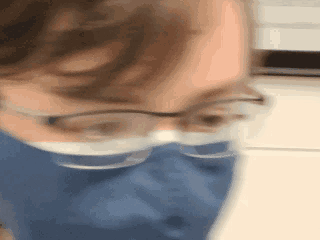 a close up of a person wearing glasses and a mask