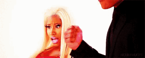 a man is brushing a woman 's hair with a toothbrush .