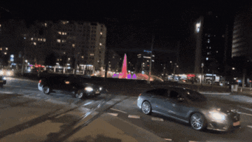 a car with a license plate that says ' a ' on it is driving down a street