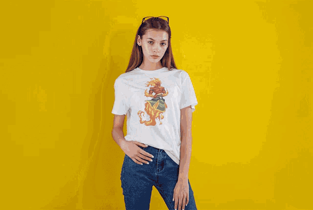 a woman is wearing a white t-shirt with a picture of a lion on it