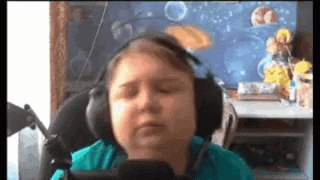 a young boy wearing headphones is sitting in a chair .