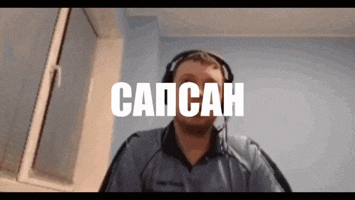 a man wearing headphones and a shirt that says capcan on it
