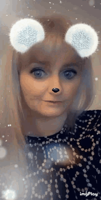 a woman wearing snowflake glasses with a black nose .