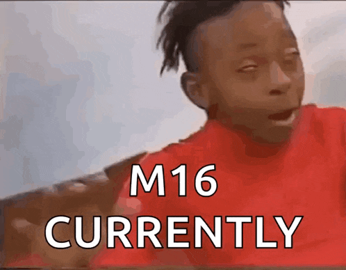 a boy in a red shirt is making a funny face with the words m16 currently below him
