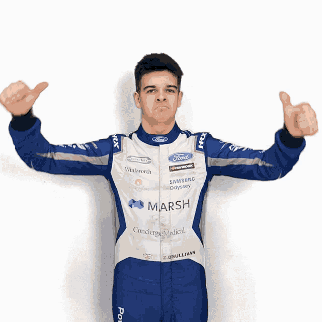 a man in a ford racing suit is giving a thumbs up