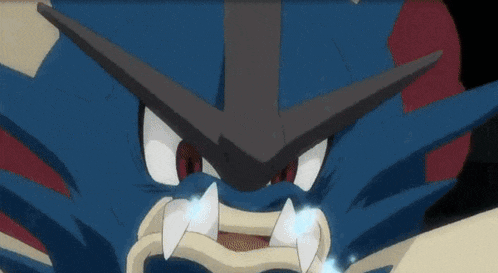 a close up of a pokemon 's face with sharp teeth .